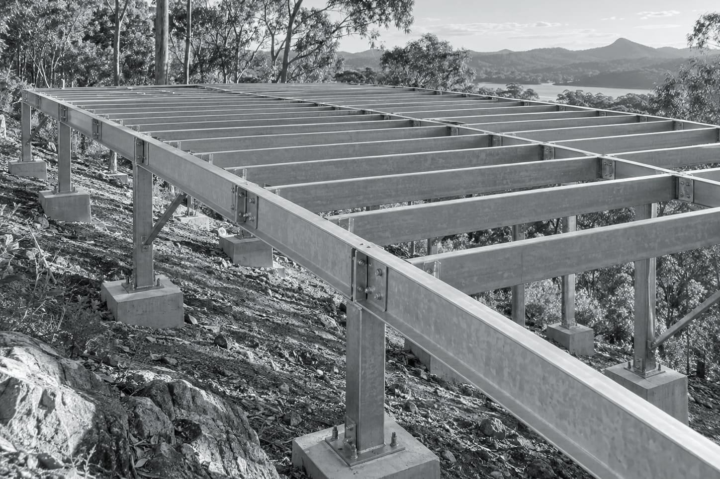 Illustrative image: light gauge steel floor joists laid across bearers on a suspended floor under construction