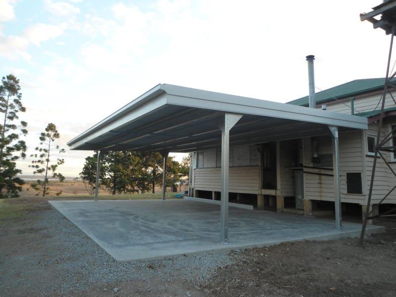Skillion carport beside a timber Queenslander