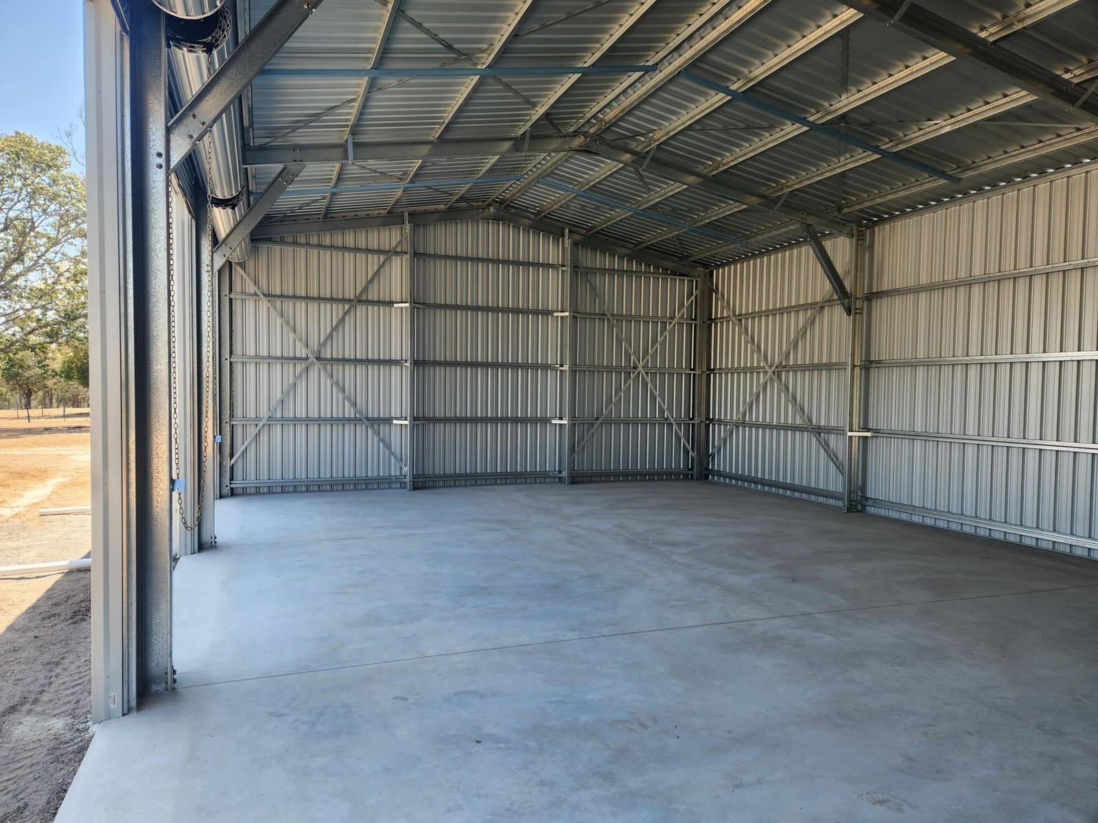 Inside a galvanised steel farm shed, portal frame and bracing