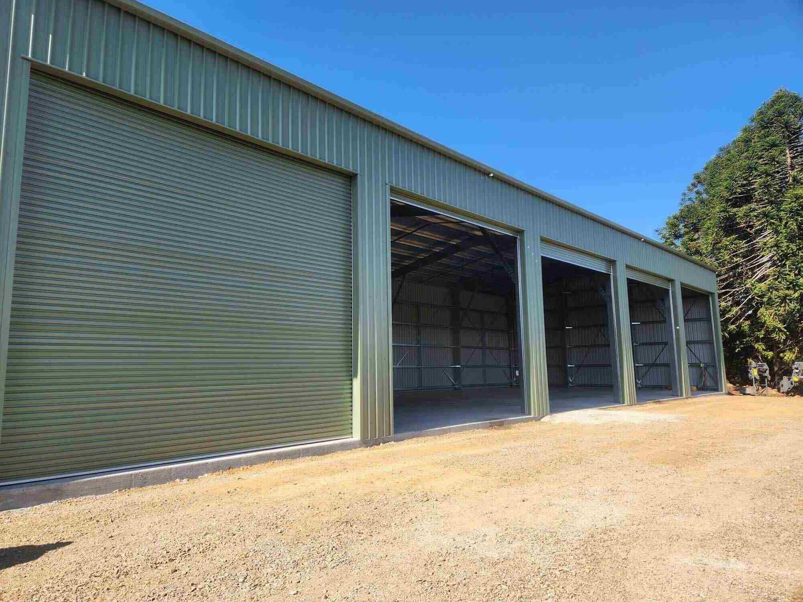 Pale green five-bay industrial shed with roller doors